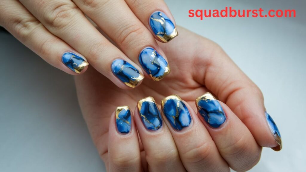 Blue marble nails with gold foil accents: Blue Fall Nail Designs
